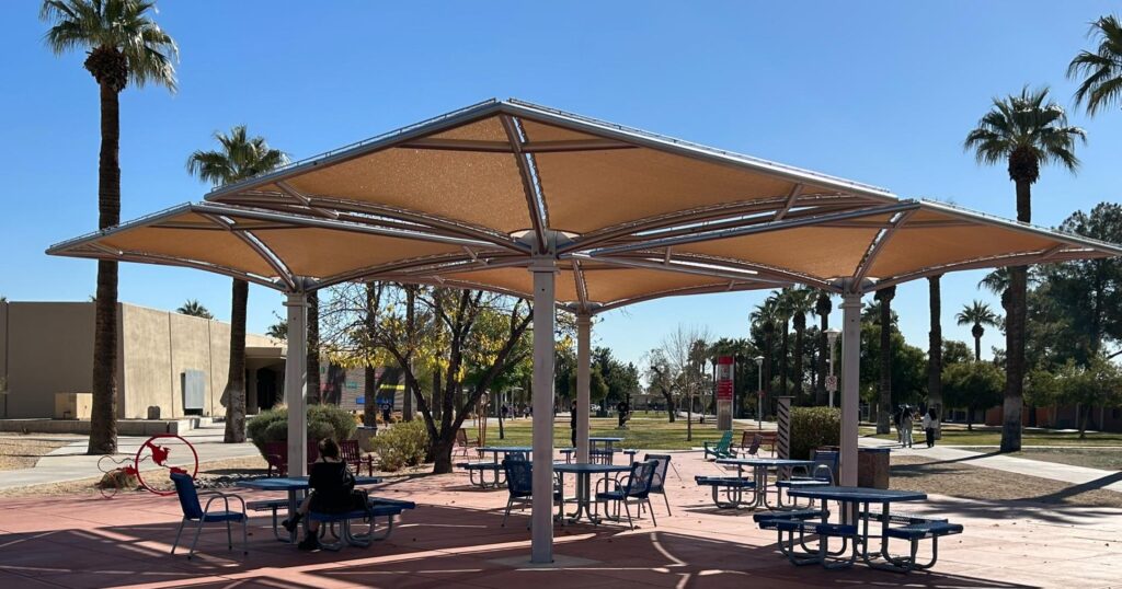 Commercial umbrella shade structure over outdoor seating