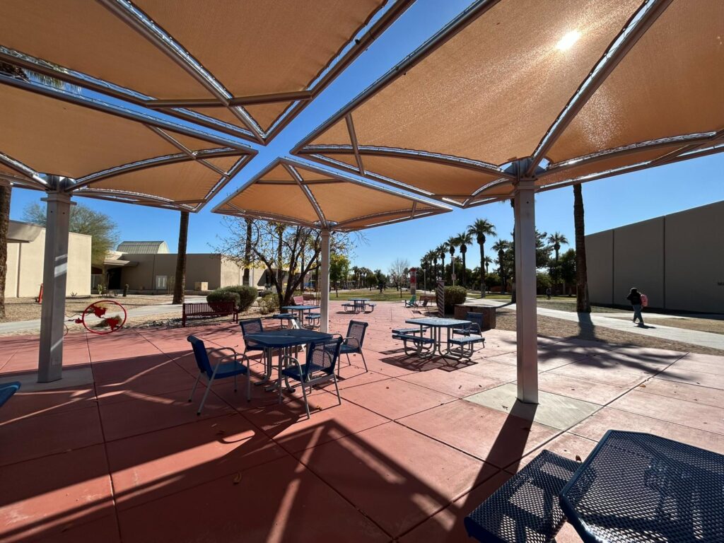 Large cantilever umbrella shade structure in open plaza