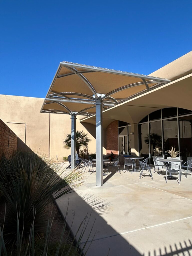 Fabric umbrella shade structure in commercial courtyard